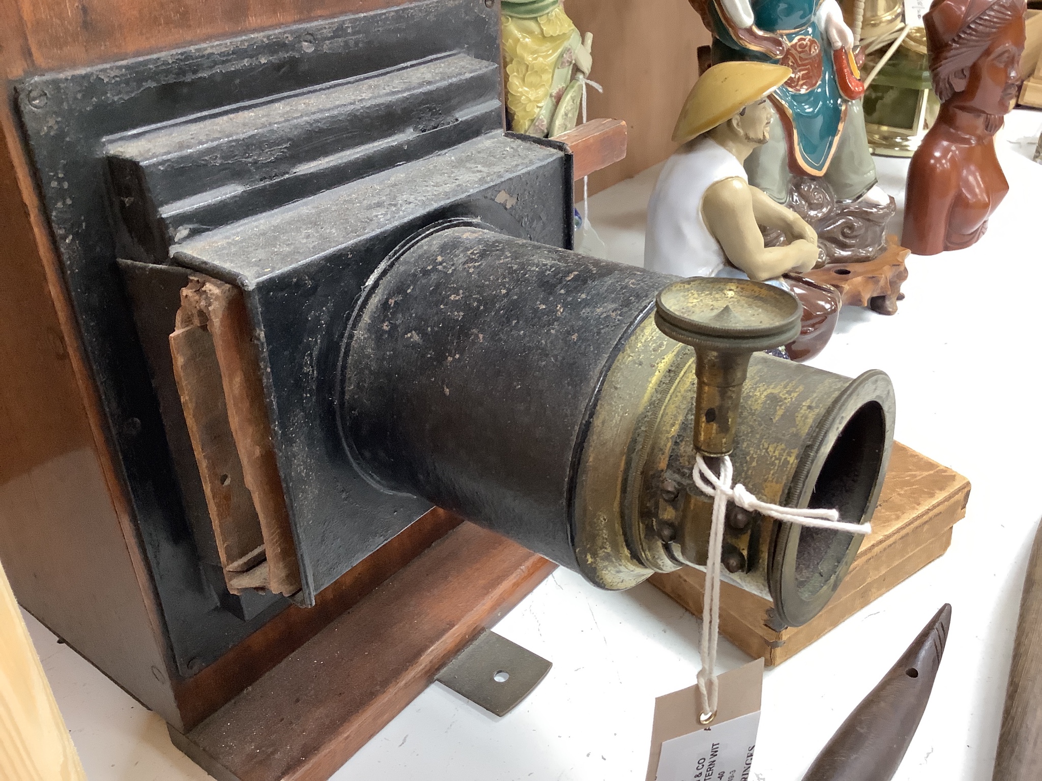 A Newton & Co Magic Lantern with slides and a group of three coconut domestic ladles